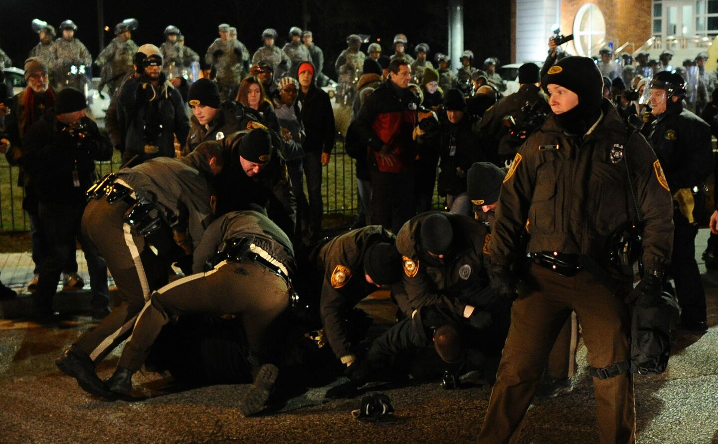 Police arrest a protester outside the Ferguson, Mo., police station on Nov. 25.