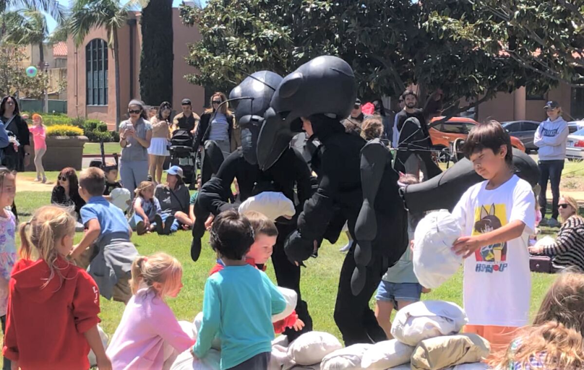 Children build a wall of "bread crumbs" with the oversize ants from Australia's Polyglot Theatre on April 23.