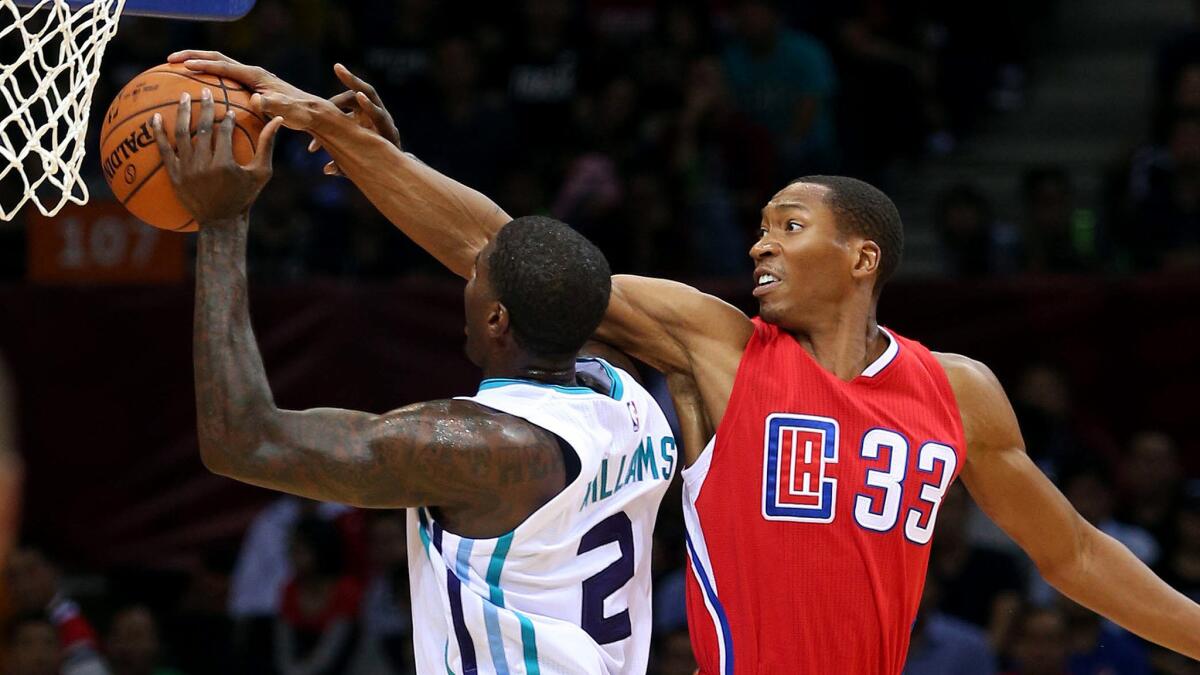 Clippers forward Wesley Johnson (33) blocks a shot by Hornets forward Marvin Williams during a preseason game.