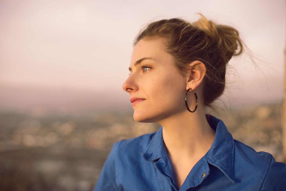 A woman in profile, with her hair in a bun