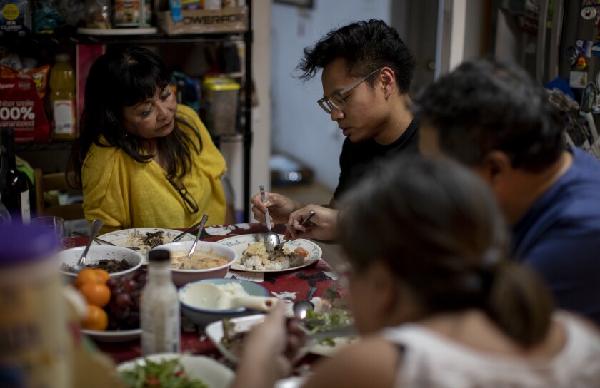 Justin Foronda, second from left, has dinner with his mother, Lina, left, brother Anthony and Anthony's girlfriend Michelle Diaz.