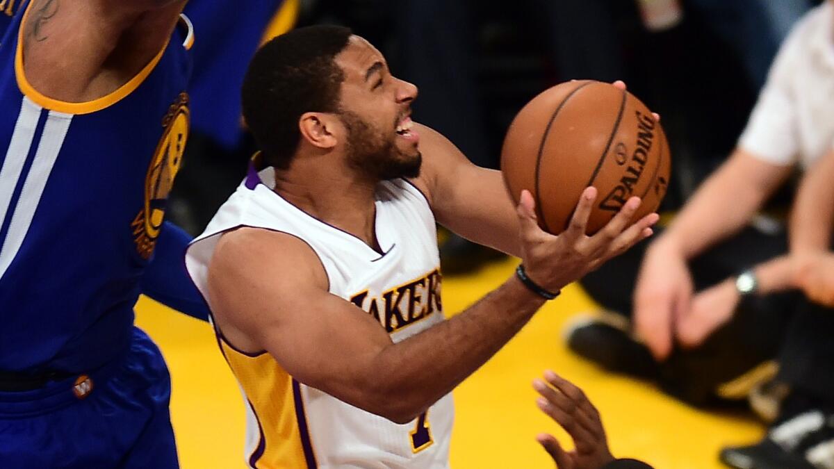 Lakers guard Xavier Henry drives to the basket during a loss to the Golden State Warriors on Nov. 16. Henry tore an Achilles' tendon in practice on Nov. 24 and is out for the season.
