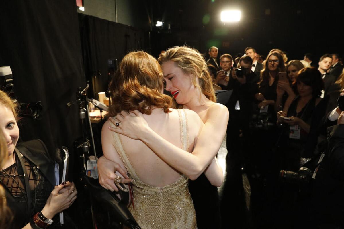Brie Larson congratulates Emma Stone on her best actress win at the 89th Academy Awards.