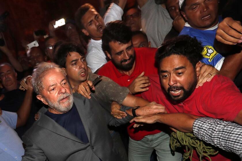 Mandatory Credit: Photo by Sebastiao Moreira/EPA-EFE/REX/Shutterstock (9569900g) Luiz Inacio Lula da Silva Lula leaves metallurgical union to turn himself in to the Police, Sao Bernardo Do Campo, Brazil - 07 Apr 2018 Former Brazilian president Luiz Inacio Lula da Silva (L) leaves the Metallurgical Union in Sao Bernardo do Campo, Brazil, 07 April 2018, to turn himself in to the authorities. Lula left the facilities as supporters tried to prevent his exit as he was heading to a Federal Police vehicle. ** Usable by LA, CT and MoD ONLY **