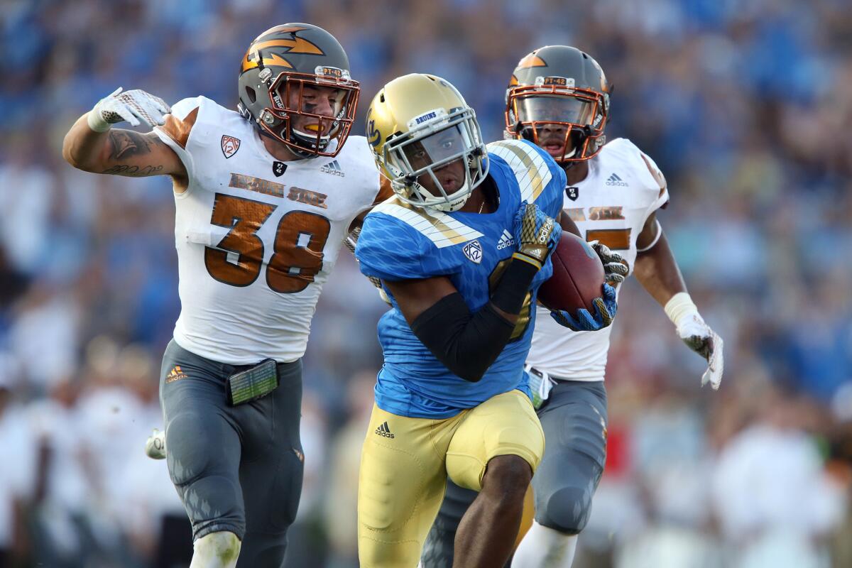 UCLA receiver Jordan Payton hauls in a long pass against Arizona State last season.