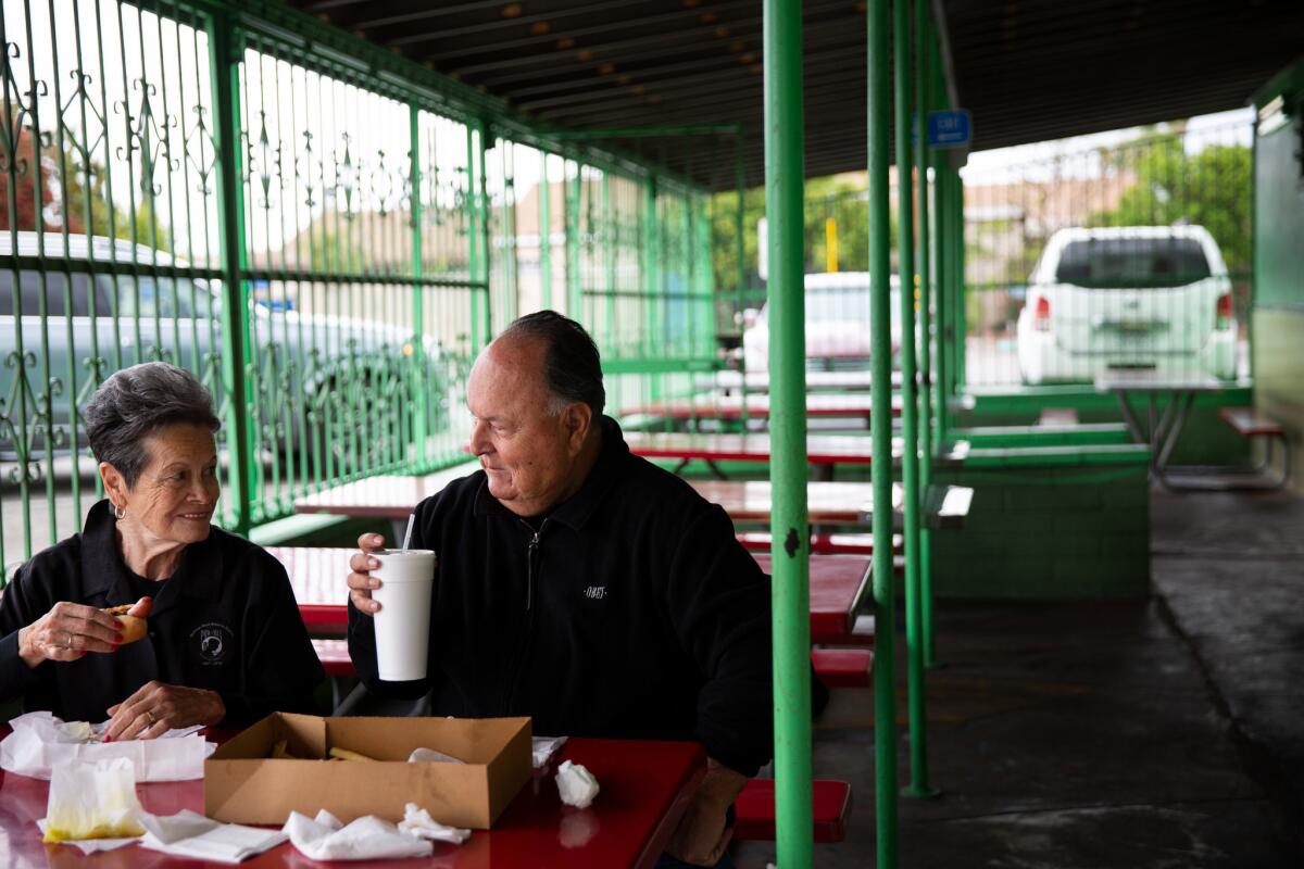 Emily and Ruben Valencia eat chili dogs and fries at Chronis' Famous Sandwich Shop in Whittier on April 16. Valencia and his best friend Raul Guerra ate chili dogs at the establishment as kids. (Dania Maxwell / Los Angeles Times)