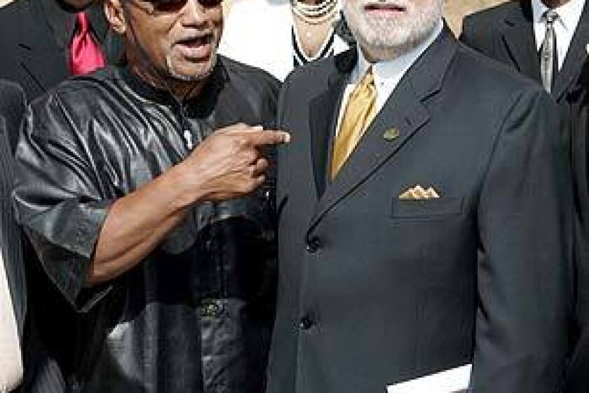 Elmer "Geronimo" Pratt, left, arrives with Danny Bakewell, of the Brotherhood Crusade of Los Angeles, for Johnnie Cochran's funeral.