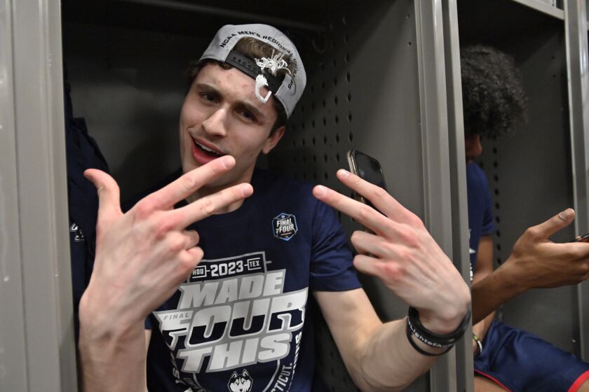 UConn guard Andrew Hurley celebrates in the locker room after the 82-54 win against Gonzaga of an Elite 8 college basketball game in the West Region final of the NCAA Tournament, Saturday, March 25, 2023, in Las Vegas. (AP Photo/David Becker)