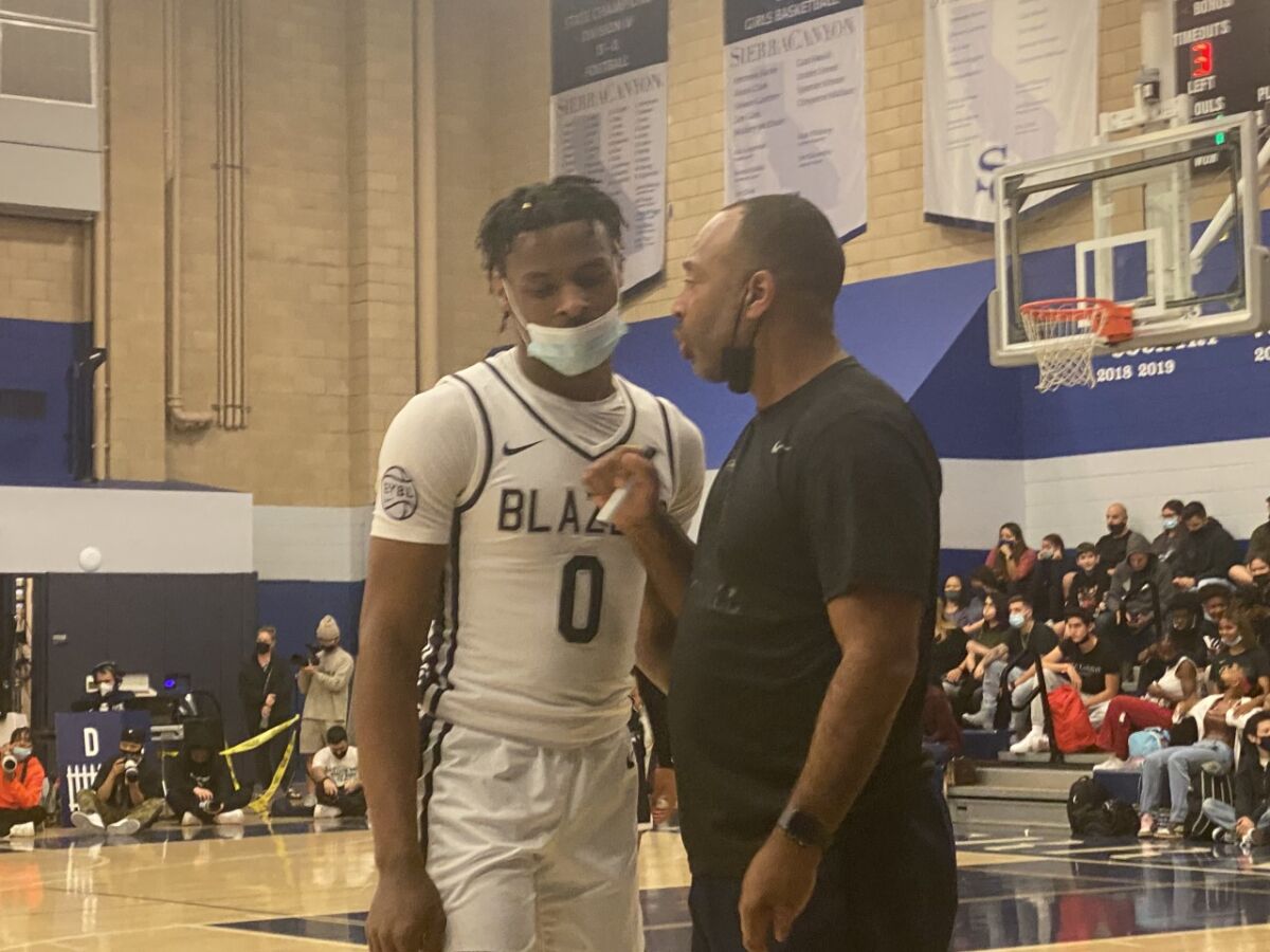 Bronny James receives instruction from Sierra Canyon coach Andre Chevalier.