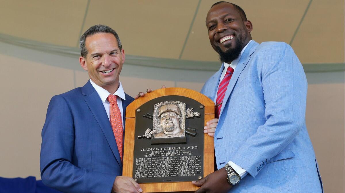 Vladimir Guerrero is presented his plaque from Hall of Fame President Jeff Idelson during the Baseball Hall of Fame induction ceremony on Sunday in Cooperstown, N.Y.