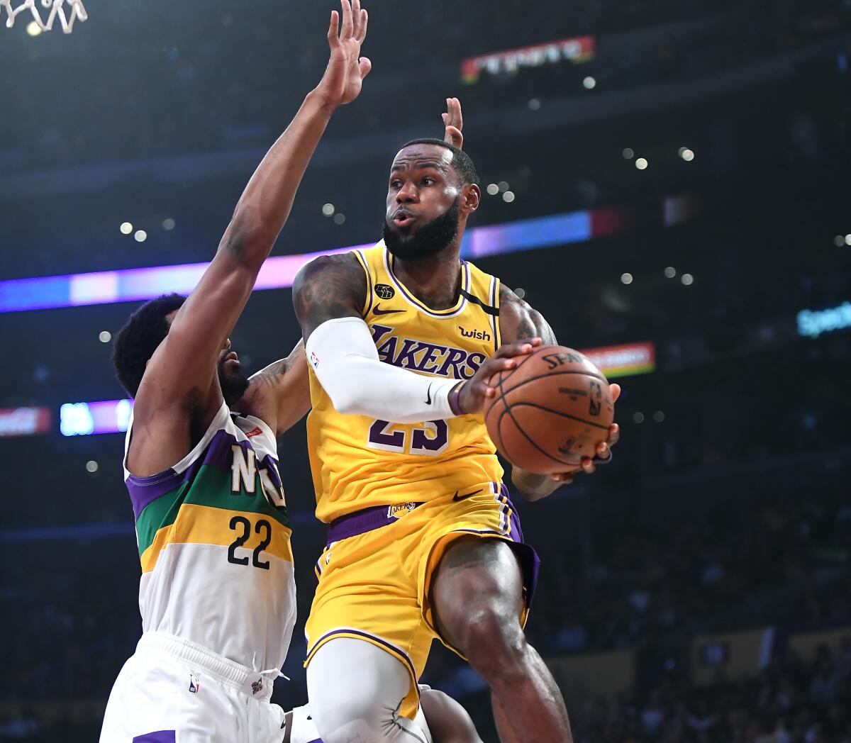 Lakers forward LeBron James drives past Pelicans forward Derrick Favors before making a pass during the first quarter of a game Feb. 25, 2020, at Staples Center.