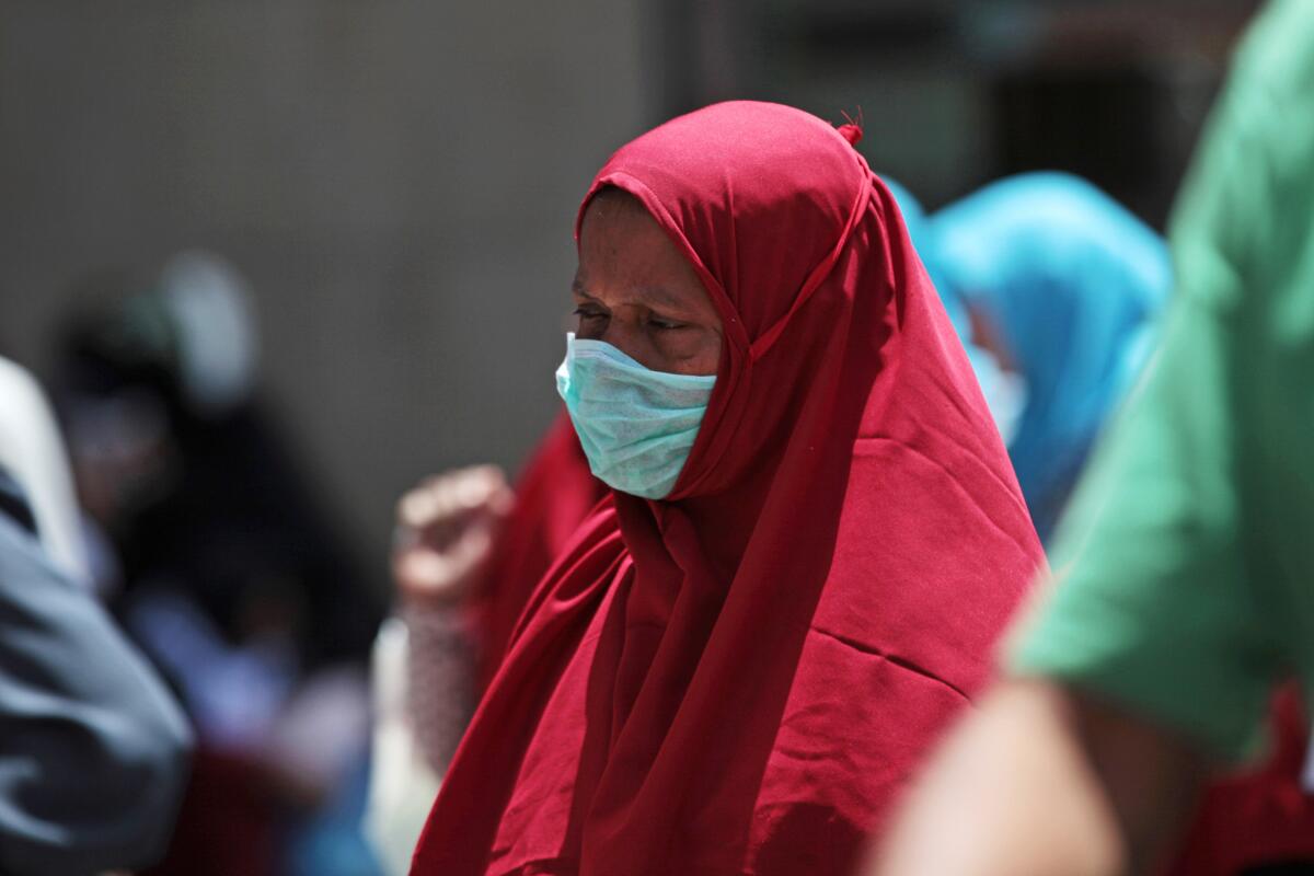 A Muslim pilgrim wears a surgical mask to prevent infection from respiratory virus known as the Middle East respiratory syndrome (MERS) in the holy city of Mecca, Saudi Arabia.