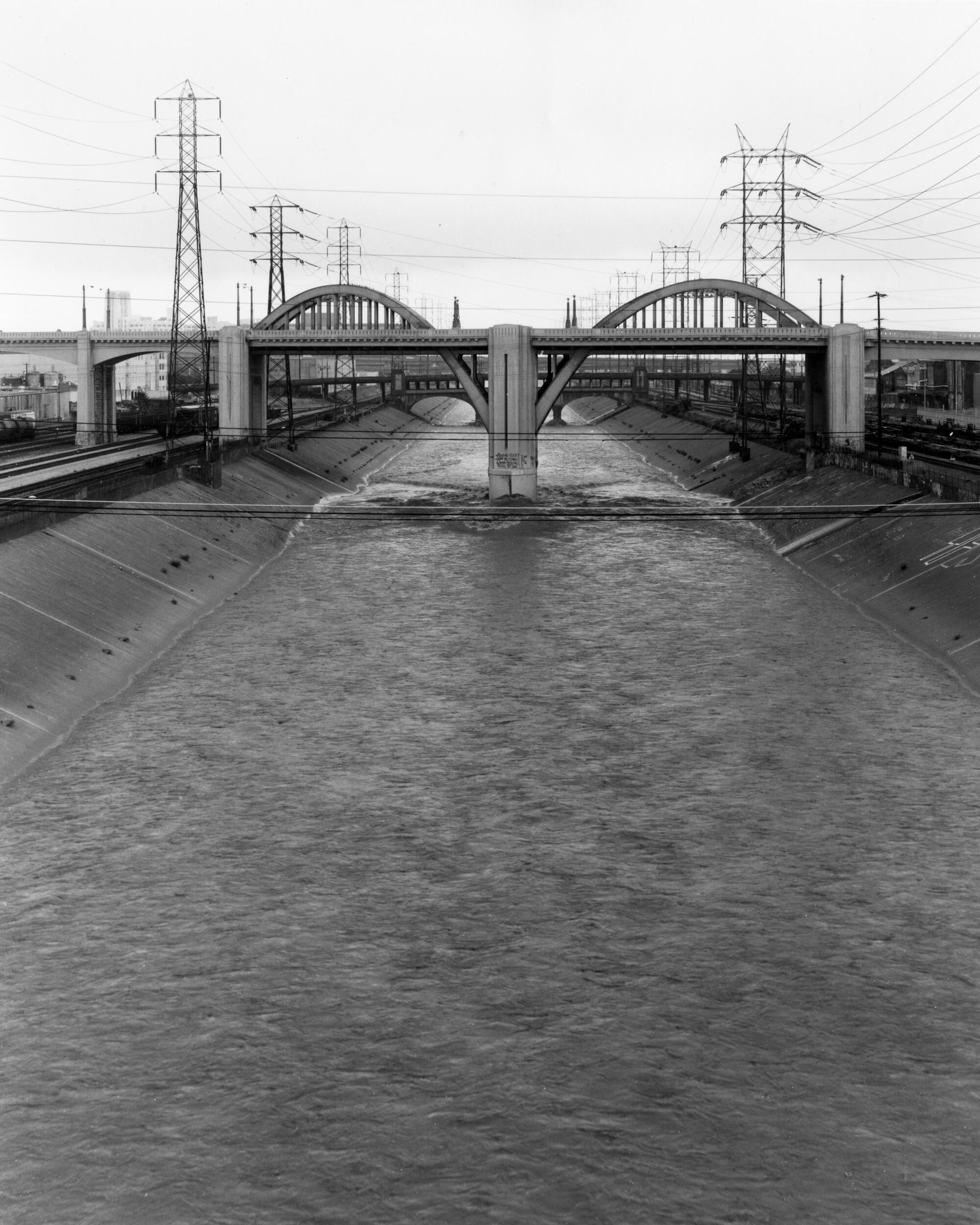 A black and white images shows the portion of the old 6th Street Viaduct running over the channelized L.A. River