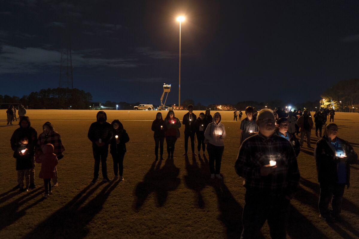 Community members gather for a candlelight vigil at Chesapeake City Park in Chesapeake, Va., Monday, Nov. 28, 2022, for the six people killed at a Walmart in Chesapeake, Va., when a manager opened fire with a handgun before an employee meeting last week. (AP Photo/Carolyn Kaster)