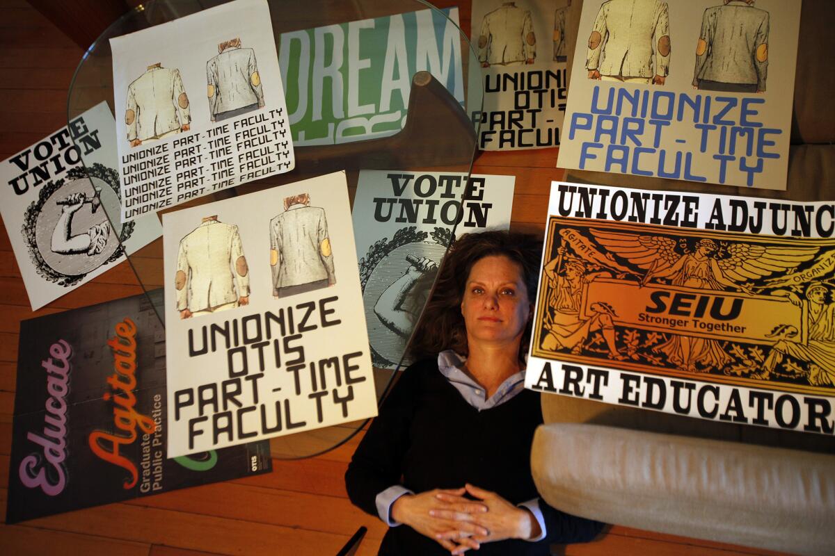 Artist Andrea Bowers, a professor working to unionize part-time faculty at the Otis College of Art and Design, with posters she designed for the cause.