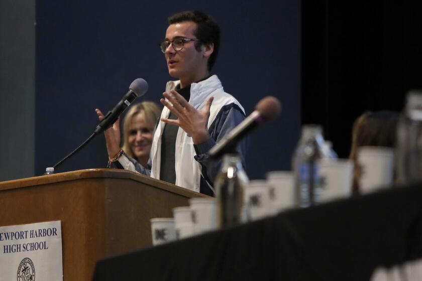 Johnny Lujan, 17, One-On-Campus ambassador at Corona Del Mar High, speaks during a One-On-Campus "awareness" panel Wednesday night at Newport Harbor High School's theater. The panel is in response to the swastika incident that happened last week, involving several high school students from Newport Beach.