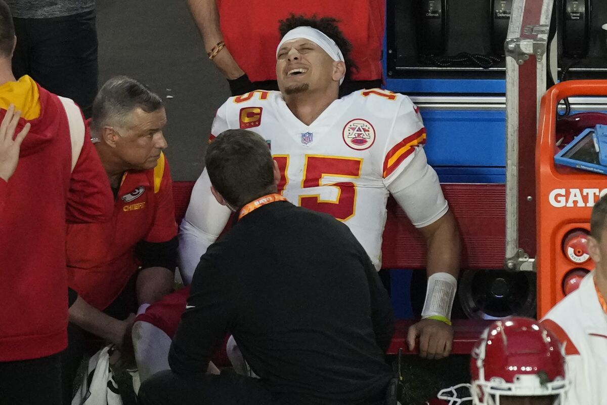 Kansas City Chiefs quarterback Patrick Mahomes grimaces on the bench after sustaining an injury in the second quarter.