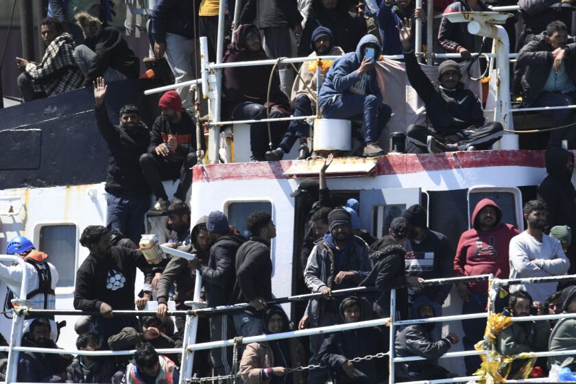 A ship carrying some 700 migrants enters the Sicilian port of Catania, Wednesday, April 12, 2023. Italy's right-wing government has declared a state of emergency to help it cope with a surge in migrants arriving on the country's southern shores. Premier Giorgia Meloni and her Cabinet on Tuesday, decided to impose the emergency status for six months. (AP Photo/Salvatore Cavalli)