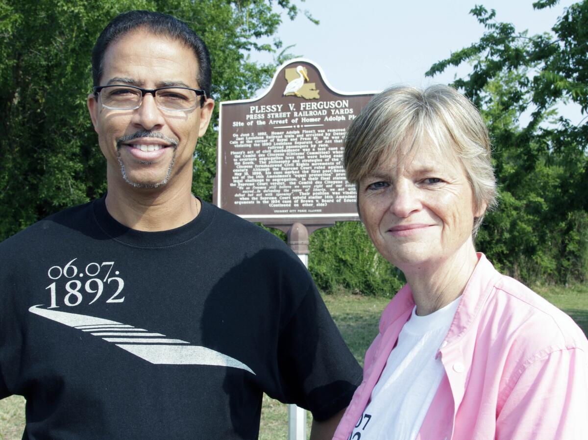 Keith Plessy and Phoebe Ferguson stand by a historical marker about the Plessy vs. Ferguson court case