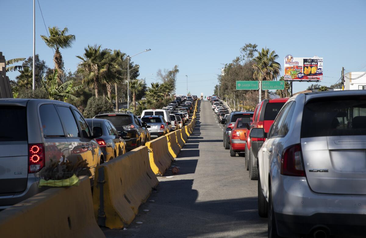 Two long lines of vehicles on a road.