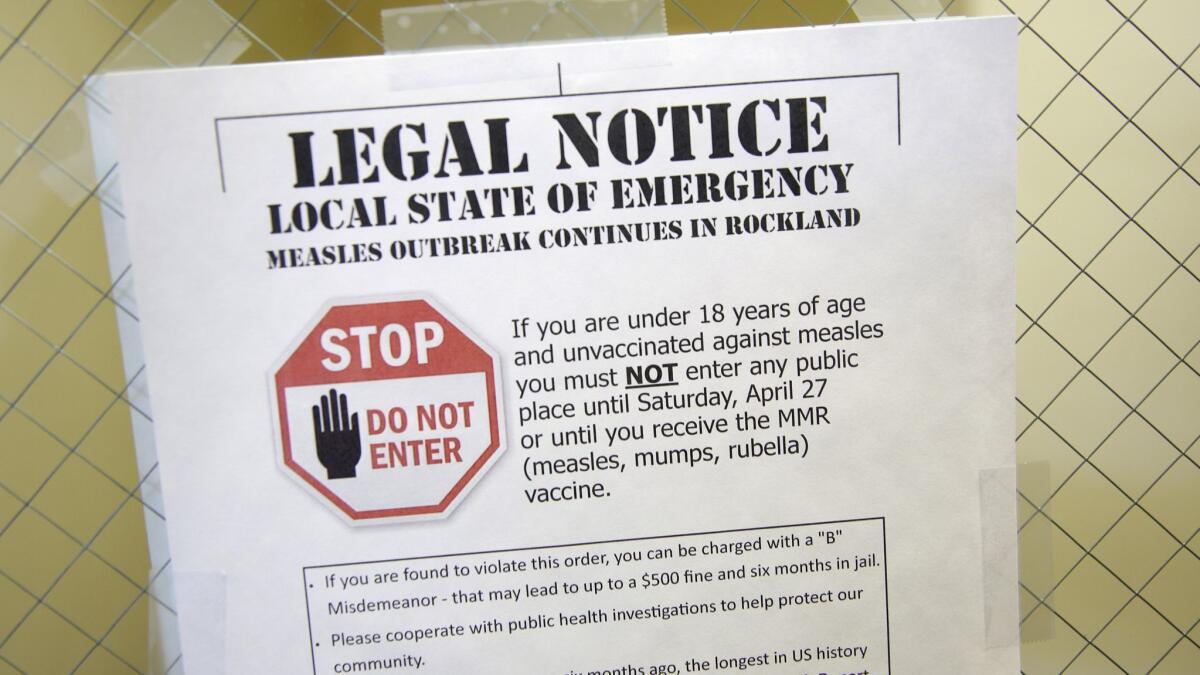 A sign at the Rockland County Health Department in Pomona, N.Y., in March 2019 warns of the local state of emergency caused by a measles outbreak.