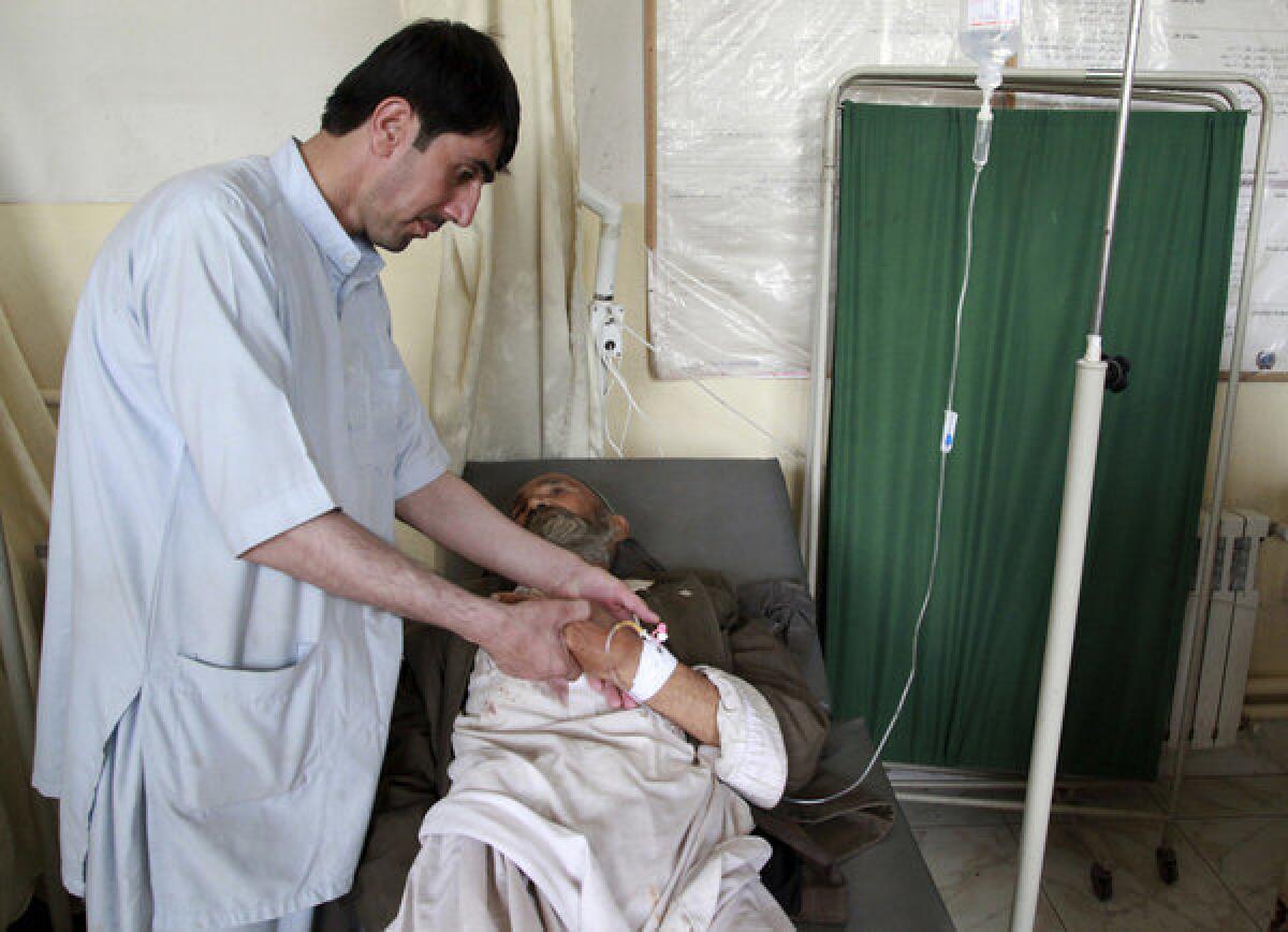 A man who was injured in a suicide attack lies on a hospital bed in the northern Afghan province of Kunduz.