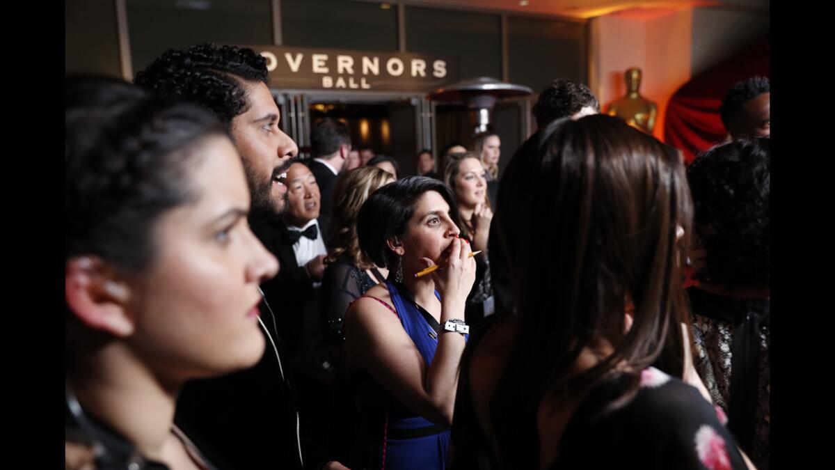 Partygoers react as the best picture mix-up is shown on monitors at the Governors Ball. (Jay L. Clendenin / Los Angeles Times)