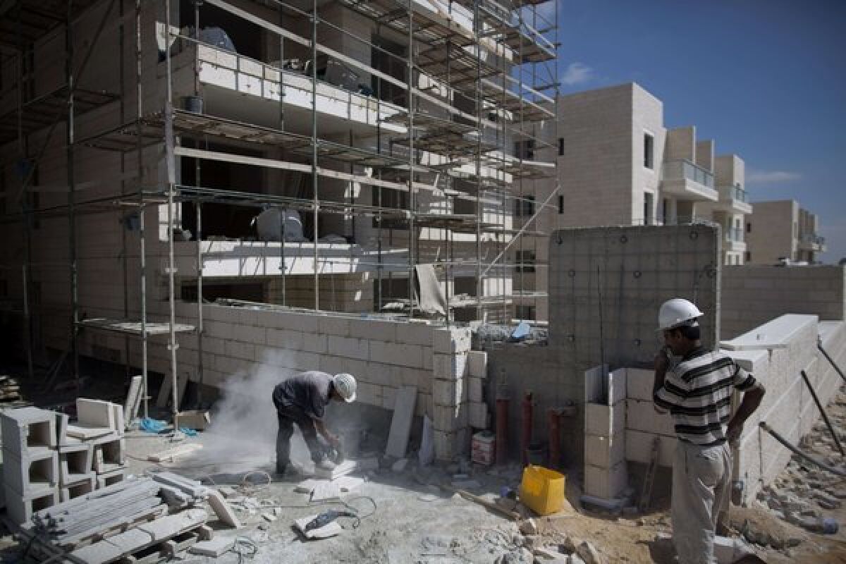 Builders work at a new housing project in the Jewish settlement of Gilo on Monday. The housing is being built on land annexed by Israel in 1967.