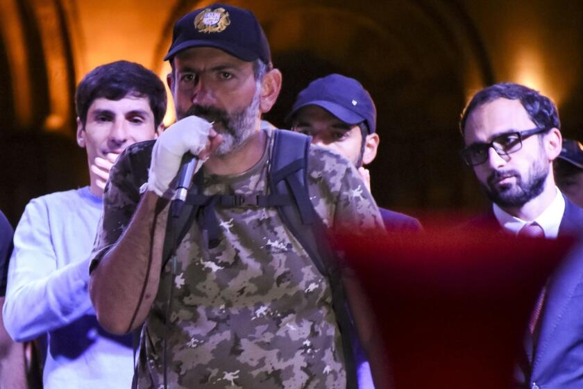 Armenian protest leader Nikol Pashinian, centre, speaks to protesters gathered at Republic Square in Yerevan, Armenia, Wednesday, April 25, 2018. Some tens of thousands of opposition supporters surged into the central square of the Armenian capital again on Wednesday, calling for the leader of their protests to become prime minister as the country labored through a dramatic political crisis. (Narek Aleksanyan/PAN Photo via AP)