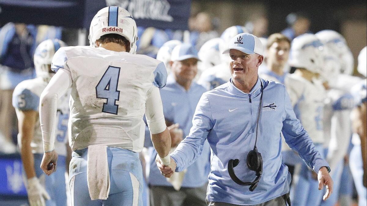 Corona del Mar High coach Dan O'Shea congratulates Ethan Garbers after the junior rushed for a three-yard touchdown in the semifinals of the CIF Southern Section Division 4 playoffs at Camarillo on Friday.