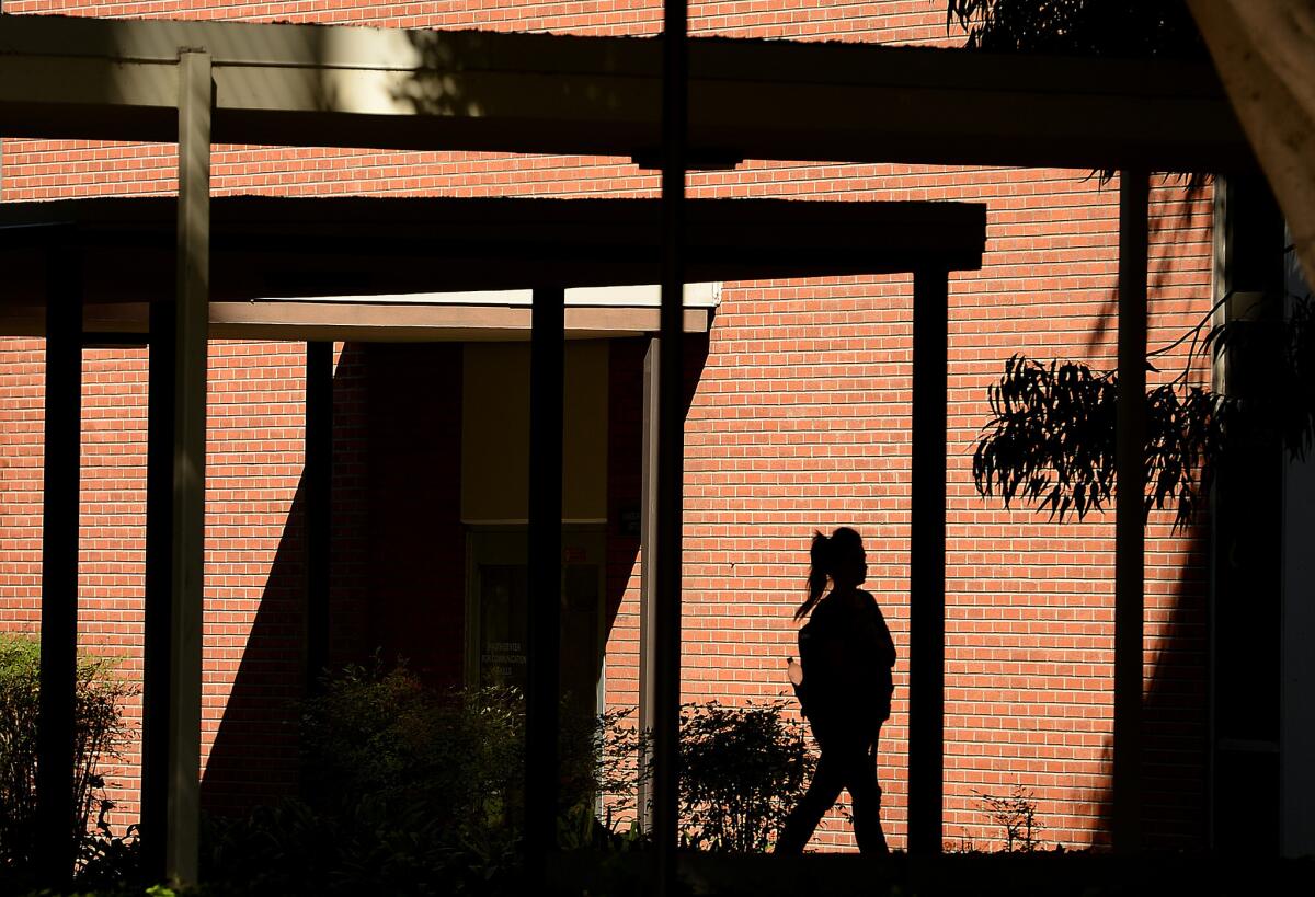 A student walks on campus at Cal State Long Beach.