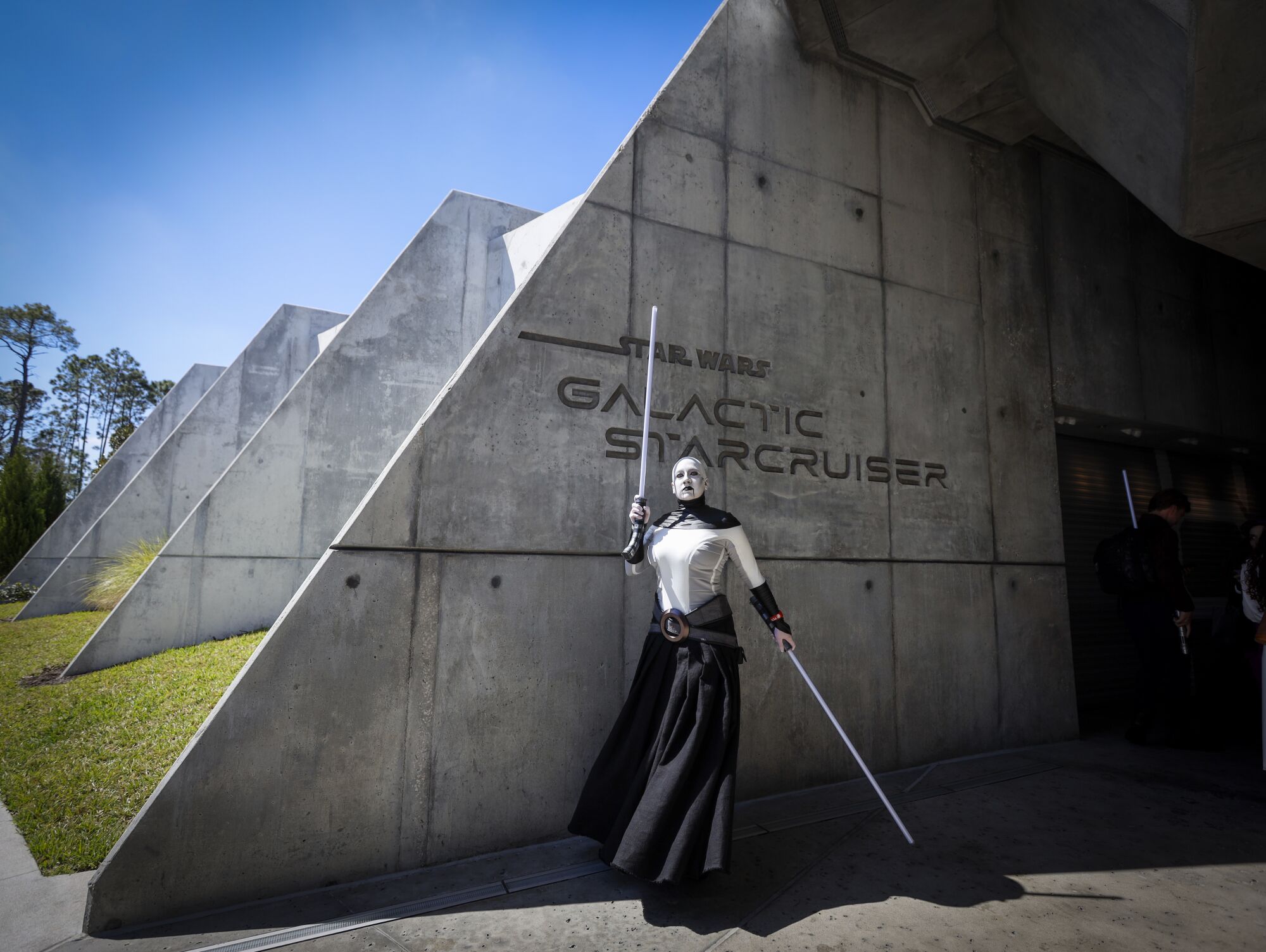 Maggie Duckworth, of St. Louis, poses as the character Asajj Ventress as the first passengers arrive.