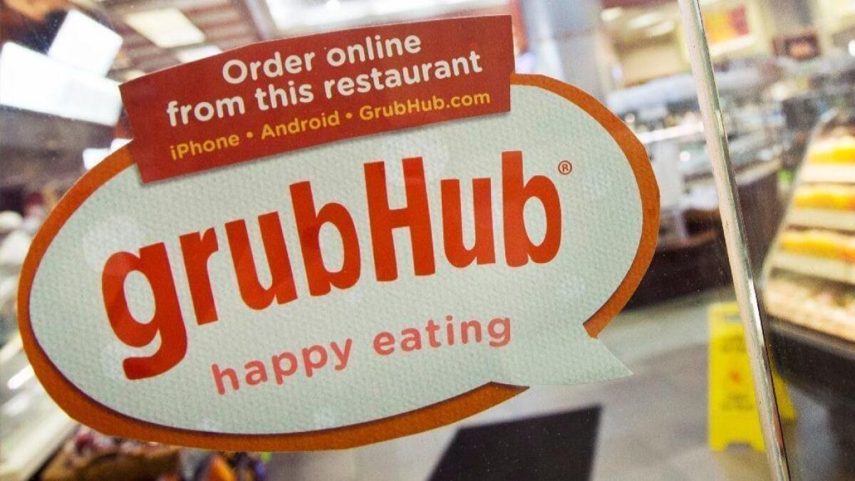 A Grubhub sign on the door of a New York restaurant.