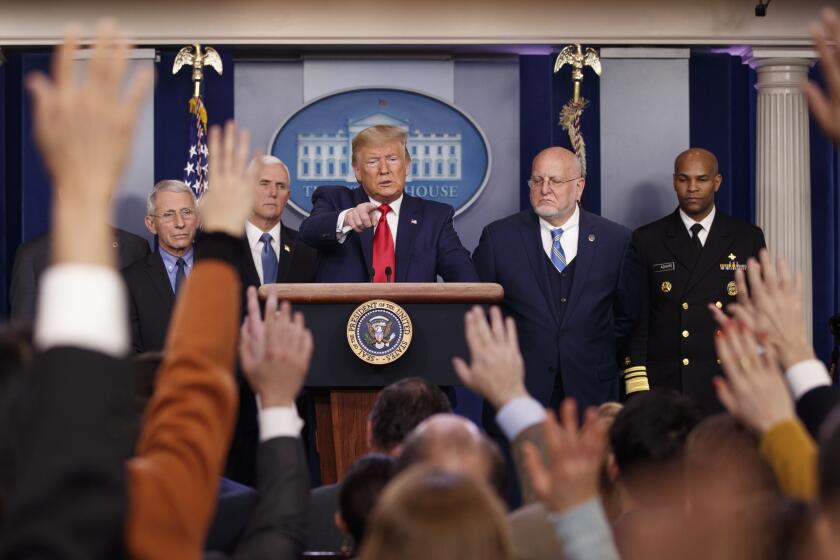 President Donald Trump, center, points as he prepares to answer question after speaking about the coronavirus in the press briefing room at the White House, Saturday, Feb. 29, 2020, in Washington, as Health and Human Services Secretary Alex Azar, National Institute for Allergy and Infectious Diseases Director Dr. Anthony Fauci, Vice President Mike Pence, Robert Redfield, director of the Centers for Disease Control and Prevention and U.S. Surgeon General Dr. Jerome Adams listen. (AP Photo/Carolyn Kaster)