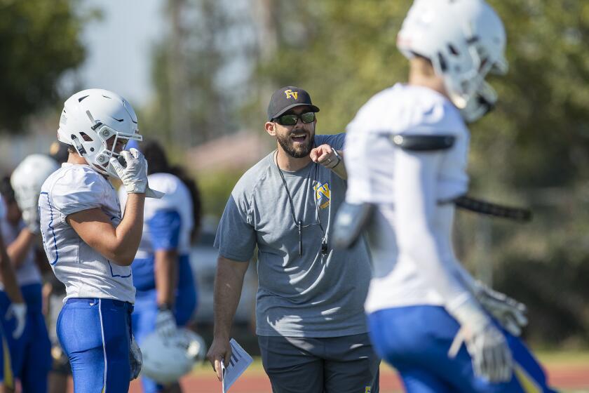 Fountain Valley's new head coach Chris Anderson gives instructions to his team during practice on Thursday, August 8.