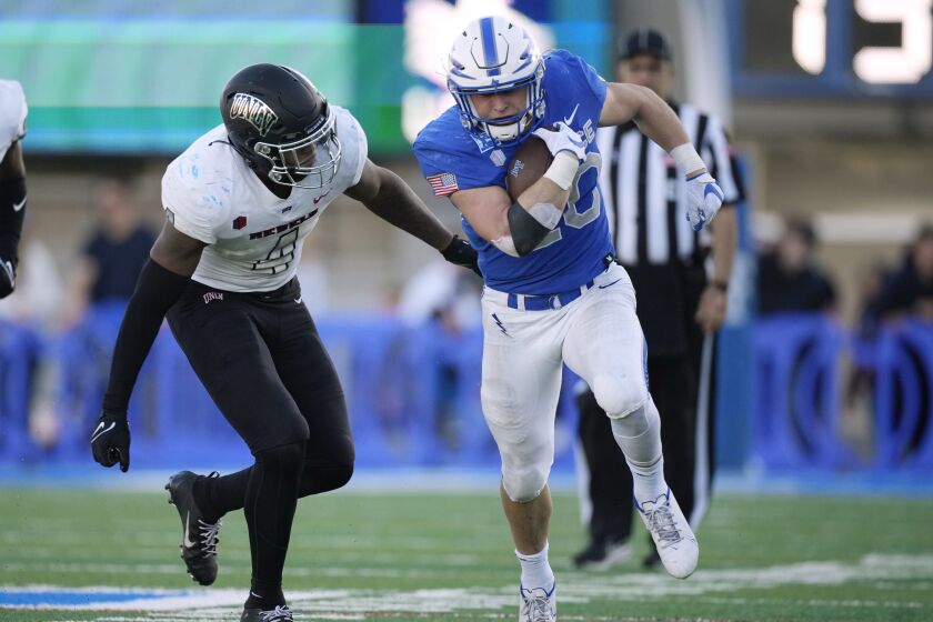 UNLV linebacker Jacoby Windmon, left, pursues Air Force running back Brad Roberts during the second half of an NCAA college football game Friday, Nov. 26, 2021, at Air Force Academy, Colo. Air Force won 48-14. (AP Photo/David Zalubowski)