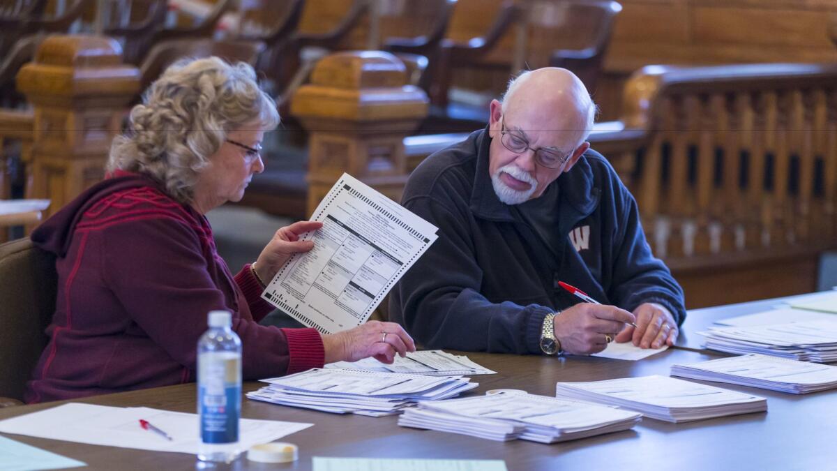 Tabulators hand count ballots on the presidential recount at the Green County Courthouse in Monroe, Wis.