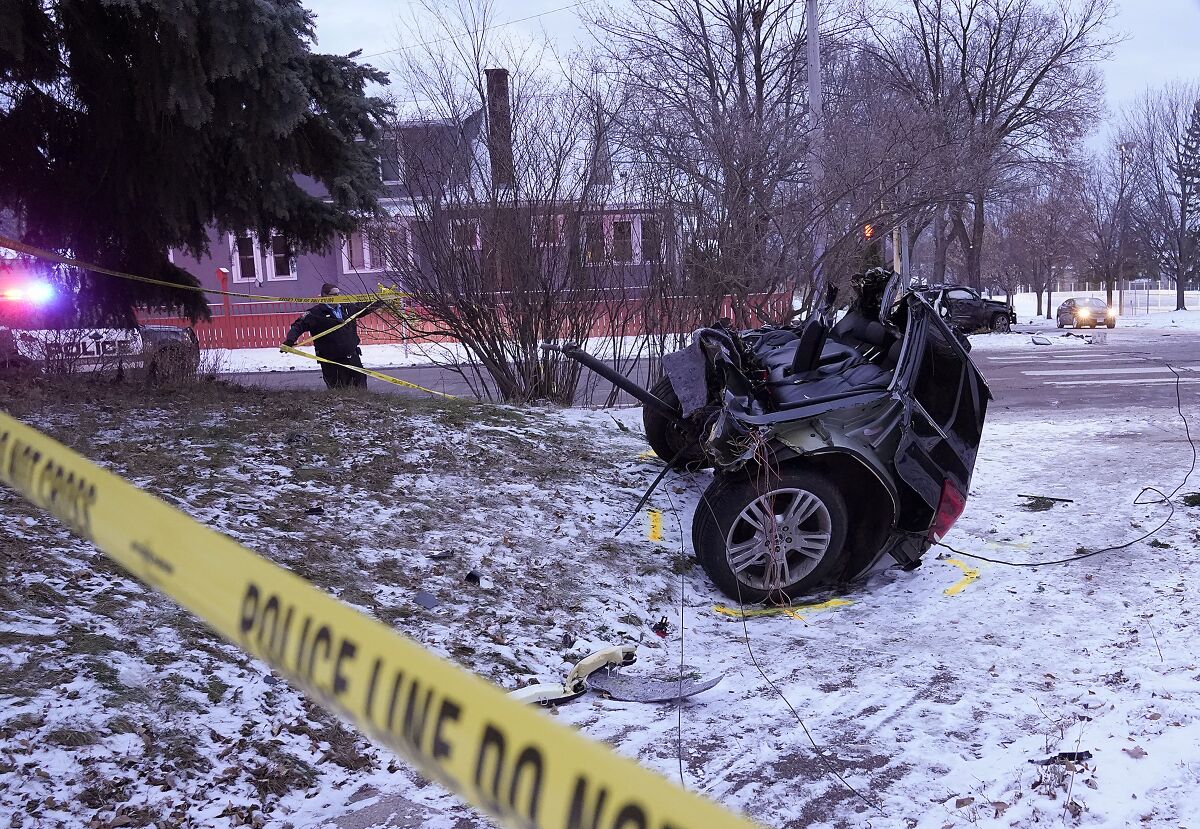 A vehicle sits in two pieces after a stolen vehicle crashed on Thursday, Dec. 9, 2021 in Minneapolis, Minn. The fatal crash in Minneapolis early Thursday followed a police pursuit of an SUV that was reportedly stolen. (David Joles/Star Tribune via AP)