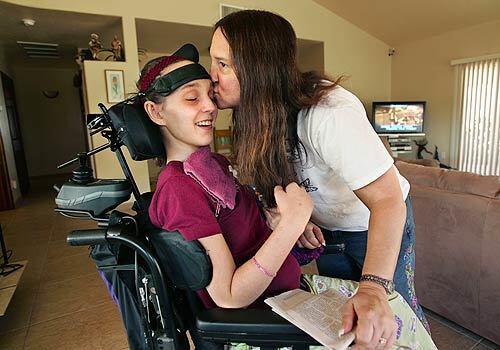 Lisa Sternberg gives a good-morning kiss to her daughter, Marissa, 23. In September 2003, Marissa was heading from Tucson to Denver for veterinary school, towing a U-Haul trailer behind her Toyota Land Cruiser. On the way, the trailer began to sway violently, and the Land Cruiser flipped, ejecting Marissa. She suffered numerous fractures as well as heart and lung damage and a severe head injury, leading to brain damage. U-Haul settled a lawsuit by her family in May 2005 without admitting liability.