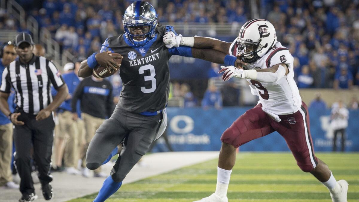 Kentucky quarterback Terry Wilson (3) is tackled by South Carolina defensive back Keisean Nixon (9) during the second half on Sept. 29.