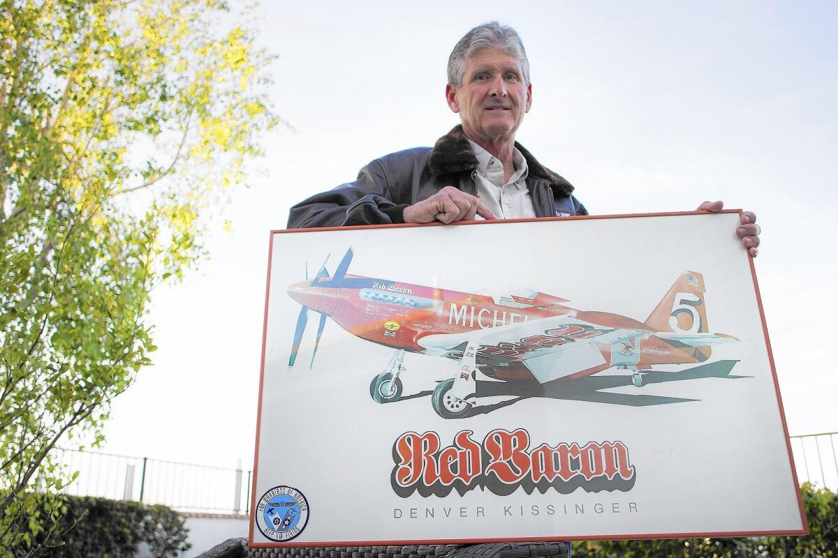 Steve Hinton of Newport Beach poses with an image of the Red Baron, a modified P-51 Mustang that he flew to a world speed record in 1979. Hinton is being inducted Wednesday into the California Aviation Hall of Fame.