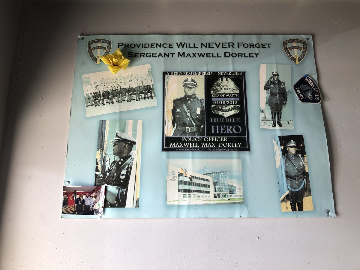 A photo display honors a slain officer. 