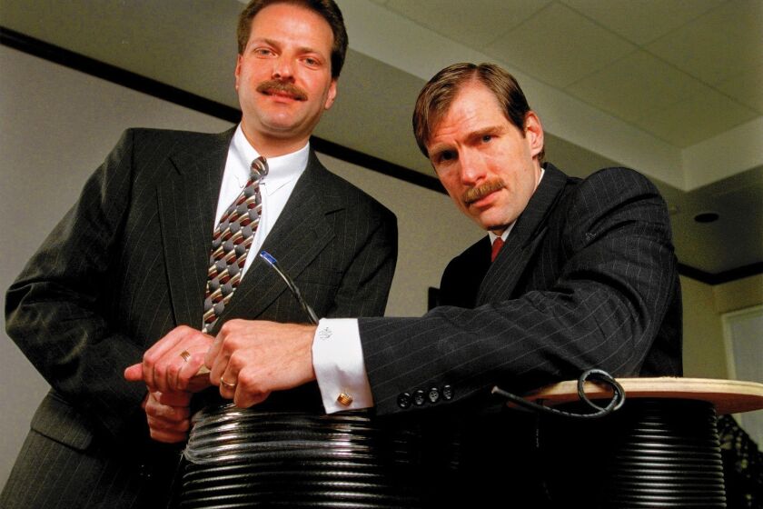 Henry Samueli, left, helped launch Broadcom out of his partner’s Westside condo in 1991. As CEO, the brash Henry T. Nicholas III, right, drove engineers to win and ran the business side.