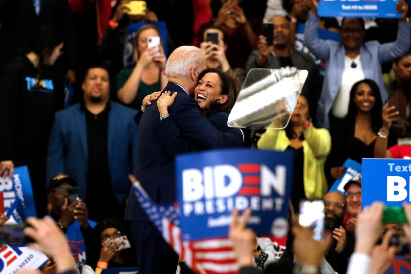 California Senator Kamala Harris (C) hugs Democratic presidential candidate former Vice President Joe Biden after she endorsed him at a campaign rally at Renaissance High School in Detroit, Michigan on March 9, 2020. (Photo by JEFF KOWALSKY / AFP) (Photo by JEFF KOWALSKY/AFP via Getty Images)