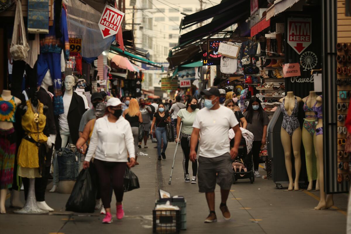 People walk along Santee Alley in downtown Los Angeles