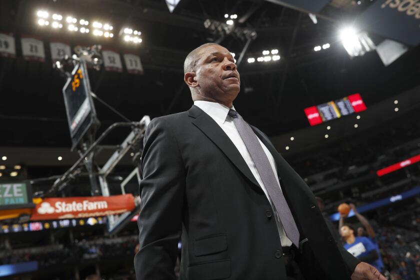 Los Angeles Clippers head coach Doc Rivers heads to the bench in the first half of an NBA basketball game against the Denver Nuggets, Sunday, Feb. 24, 2019, in Denver. (AP Photo/David Zalubowski)
