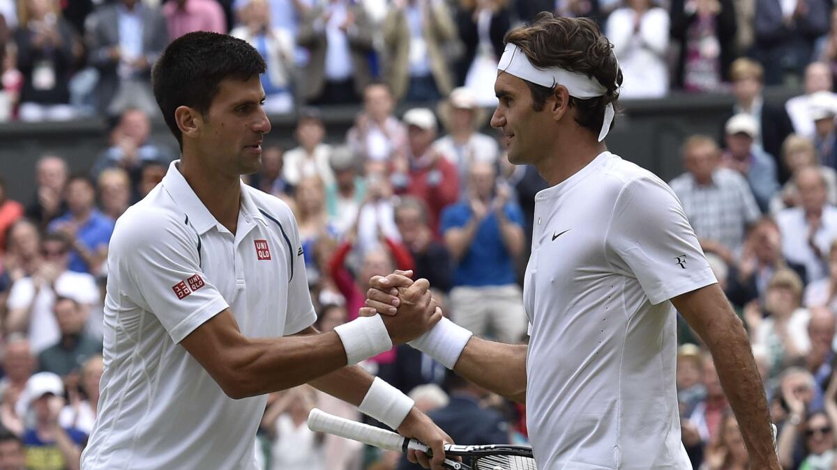 Novak Djokovic, left, shakes hands with Roger Federer after claiming his third Wimbledon singles title on Sunday.