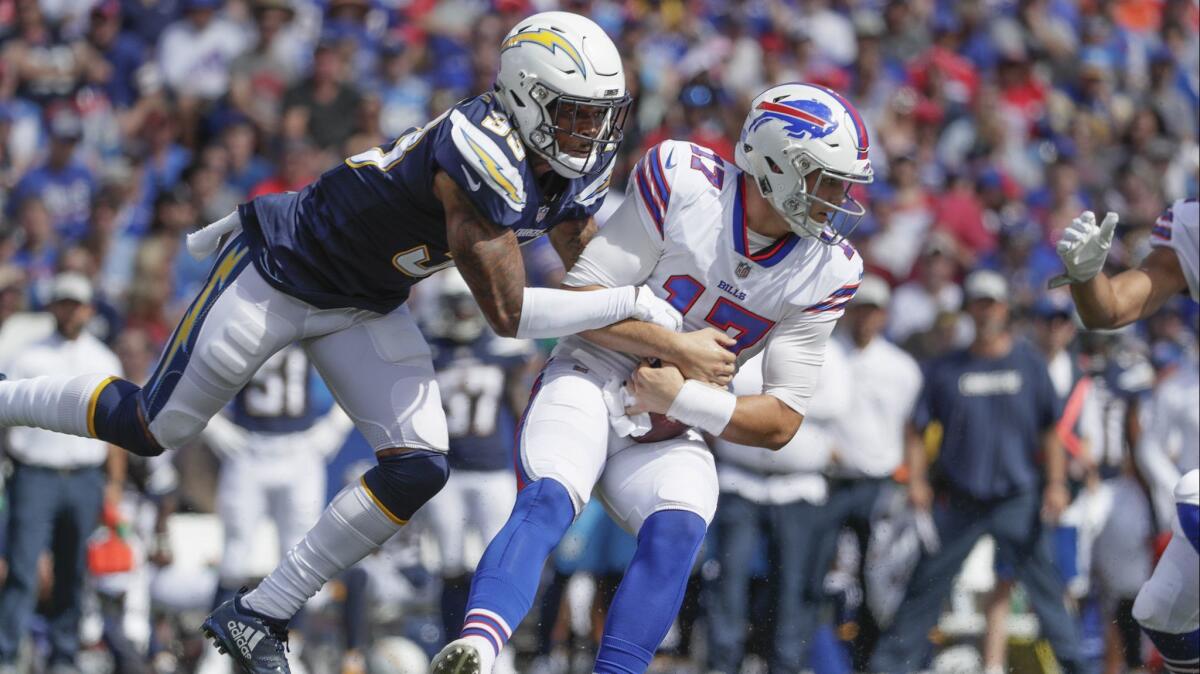 Chargers safety Derwin James sacks Buffalo Bills quarterback Josh Allen during first half action at New Era Field in Buffalo, N.Y. on Sunday.