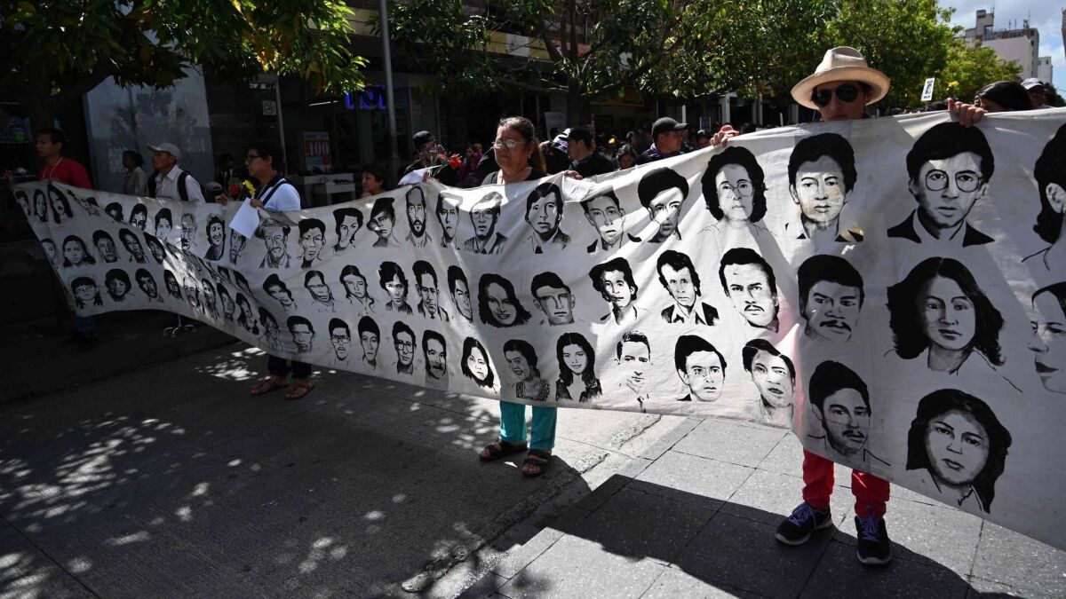 Relatives hold a banner with images of victims of the Guatemalan civil war. A U.N. report in 1999 confirmed that more than 200,000 people died or disappeared during the 36-year civil war and held Guatemala's army responsible of 90% of the crimes.