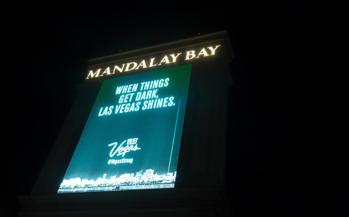 A marquee at Mandalay Bay Resort and Casino displays a message in tribute to the victims of the recent mass shooting on Oct. 8, 2017, in Las Vegas. The marquees at resorts all along the Las Vegas Strip displayed the message "When things get dark, Las Vegas shines." after they went dark at 10:05 p.m. for 11 minutes Sunday night, marking the time and duration one week ago of the shooting at the Route 91 Harvest country music festival.
